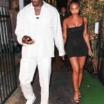 Damson Idris and Lori Harvey leaving a venue in coordinated date-night outfits — Idris in all-white and Lori in a black mini dress Damson Idris and Lori Harvey leaving a venue in coordinated date-night outfits — Idris in all-white and Lori in a black mini dress
