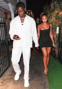 Damson Idris and Lori Harvey leaving a venue in coordinated date-night outfits — Idris in all-white and Lori in a black mini dress Damson Idris and Lori Harvey leaving a venue in coordinated date-night outfits — Idris in all-white and Lori in a black mini dress
