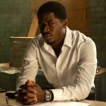 Damson Idris as Franklin Saint in Snowfall, wearing a crisp white dress shirt in a tense scene Damson Idris as Franklin Saint in Snowfall, wearing a crisp white dress shirt in a tense scene