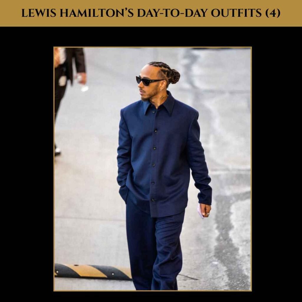 lewis-hamilton-day-to-day-outfits-4 Lewis Hamilton in a full navy outfit, styled with matching jacket and trousers, dark sunglasses, and braids pulled back.