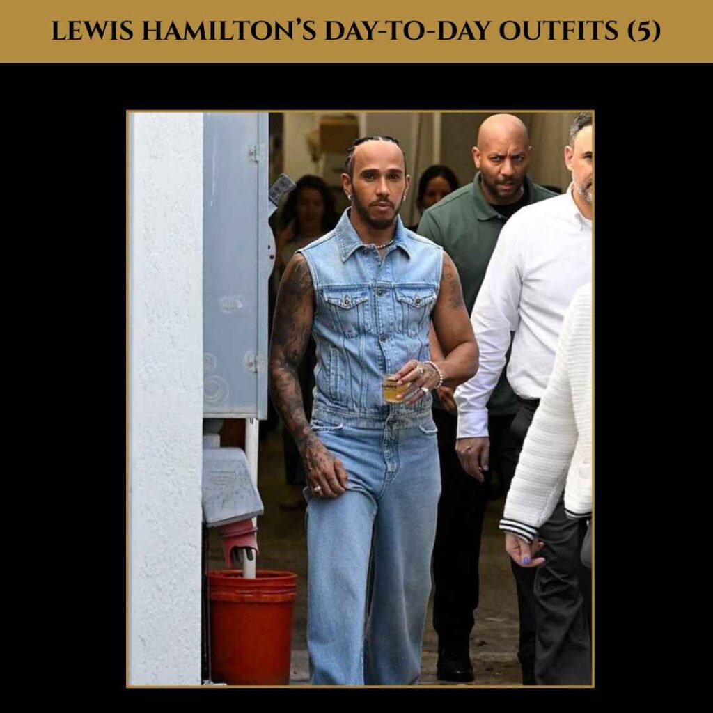 lewis-hamilton-day-to-day-outfits-5 Lewis Hamilton rocking a denim-on-denim look with a sleeveless vest and loose-fit jeans, showing off his tattoos in a bold casual outfit.