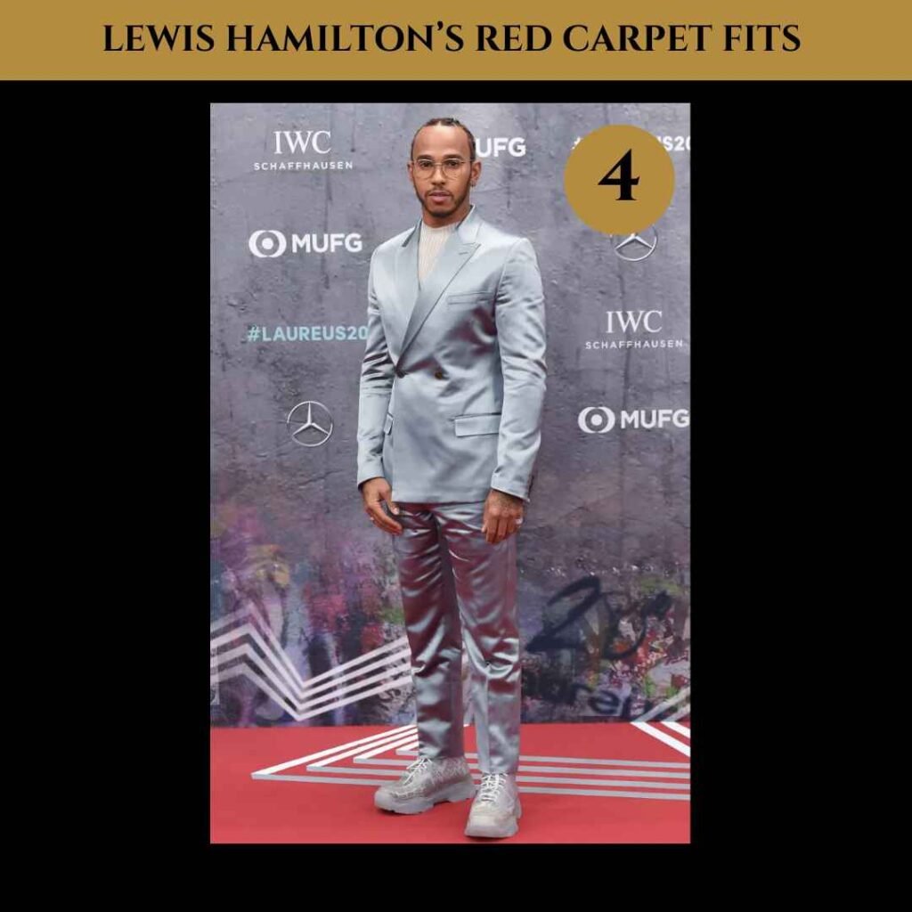 lewis-hamilton-red-carpet-fits (4) Lewis Hamilton on the red carpet wearing a shiny silver double-breasted satin suit with matching pants, styled with a ribbed turtleneck and chunky grey sneakers.