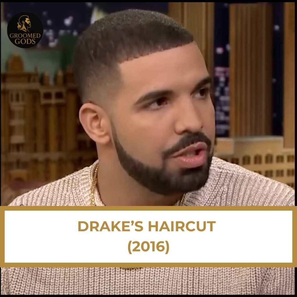 Drake’s Haircut 2016 – Mid Fade Buzz Cut Drake’s 2016 haircut featuring a mid-fade buzz cut with a sharp beard line, shown during an interview.