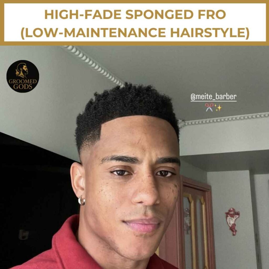 Young Black man with a high fade and sponged fro, wearing a red polo shirt and earrings.