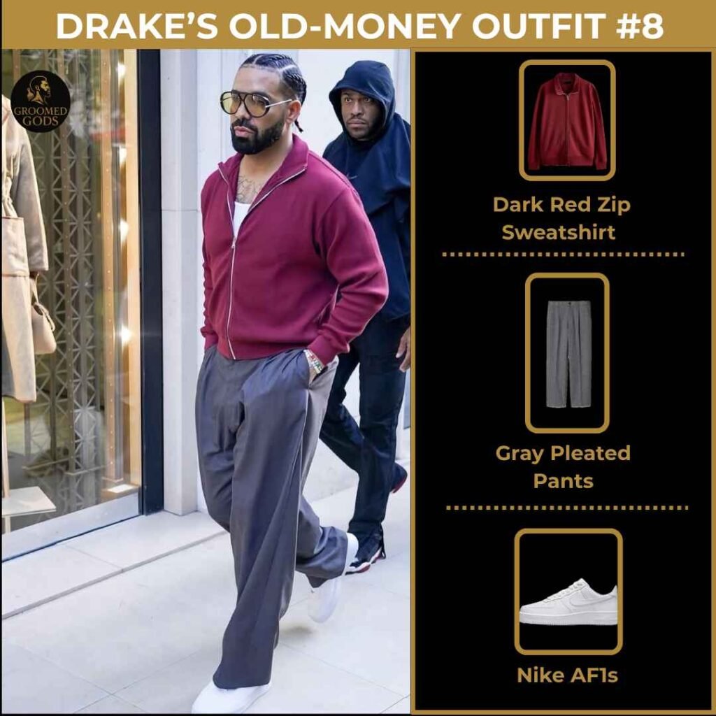 Drake’s Old-Money Outfit #8 – Dark Red Zip, Pleated Pants, Nike AF1s Drake wearing an old-money style outfit with a dark red zip sweatshirt, gray pleated pants, and Nike Air Force 1 sneakers.
