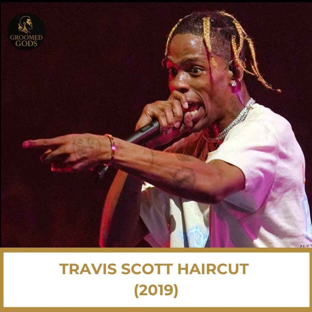 Travis Scott Haircut (2019) Travis Scott performing on stage wearing blonde high-taper braids, showcasing his 2019 signature hairstyle.