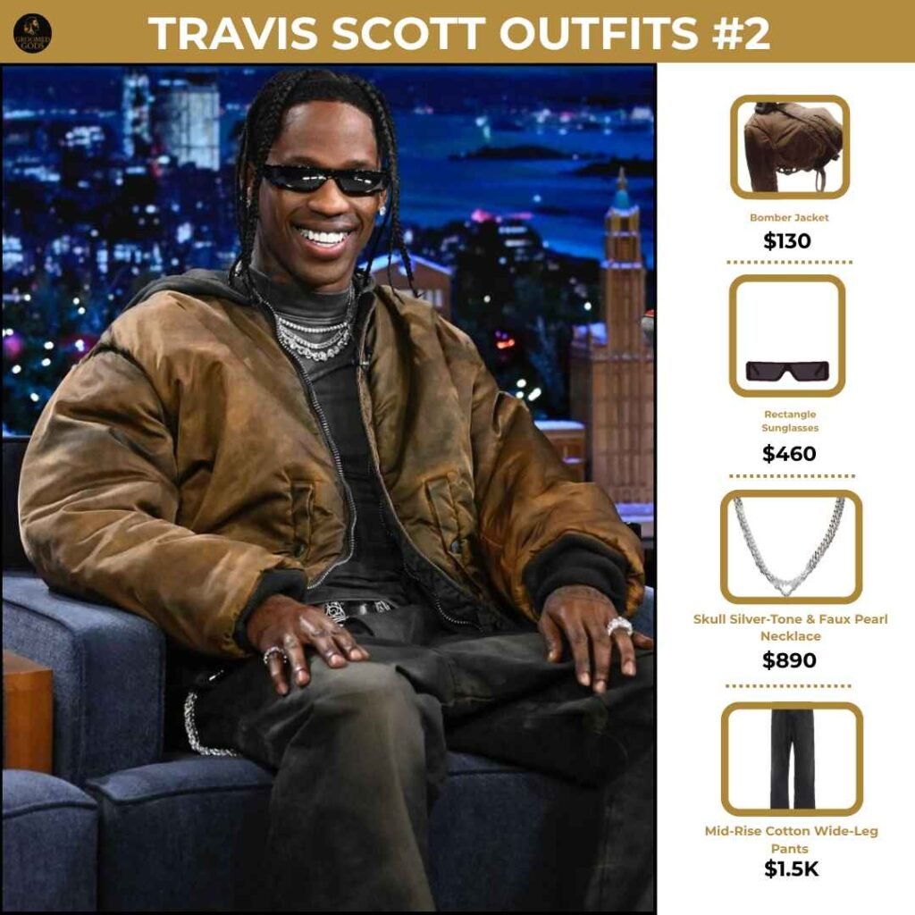 Travis Scott Outfit Breakdown #2 Travis Scott wearing a bomber jacket, wide-leg Balenciaga pants, and layered jewelry during an interview, showcasing his relaxed luxury style.
