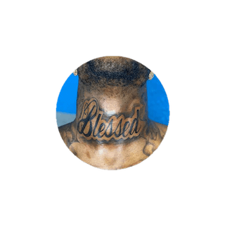 Black man with a neck tattoo featuring blessed