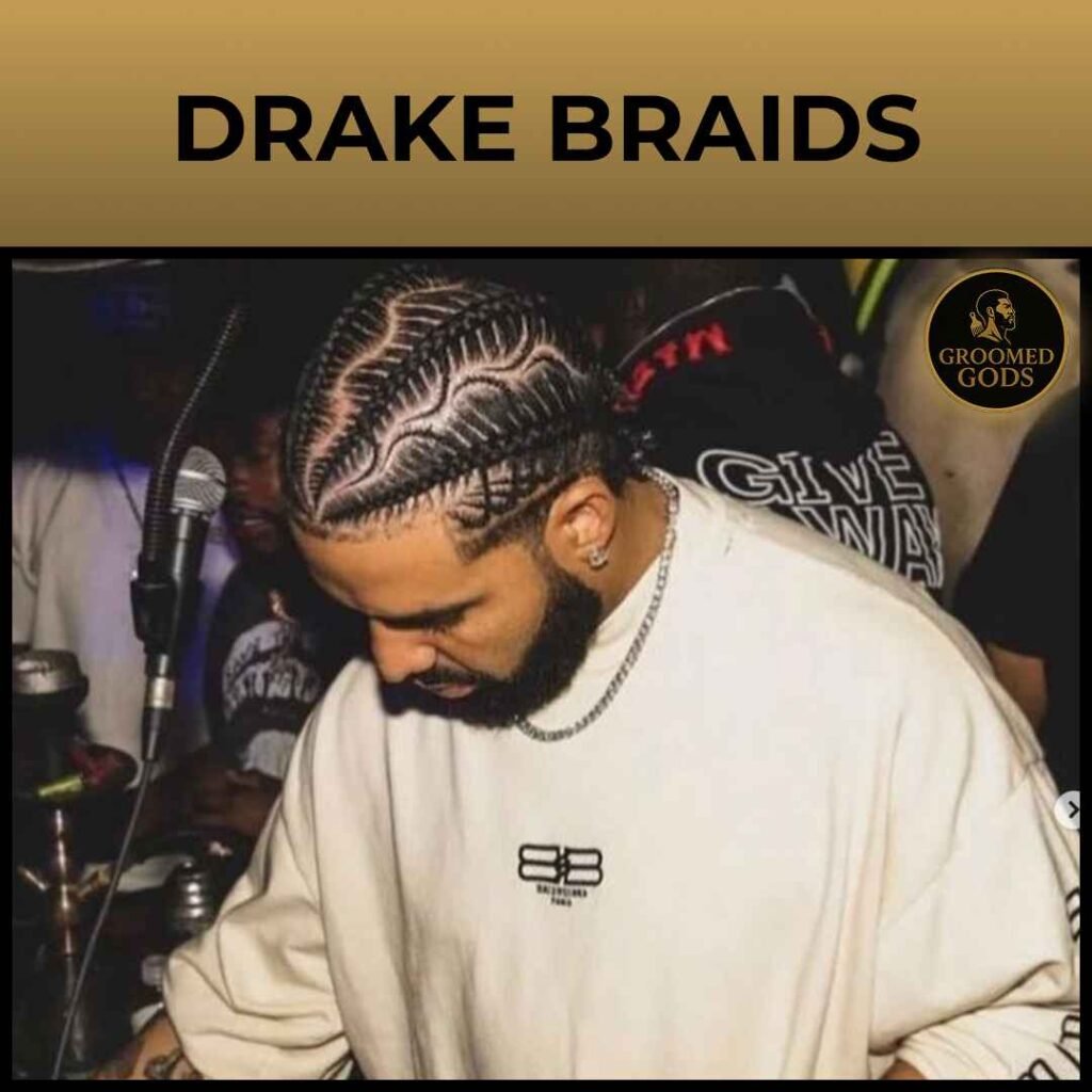 Close up of Drake with curved stitch braids and a detailed part design, head down in a club setting.