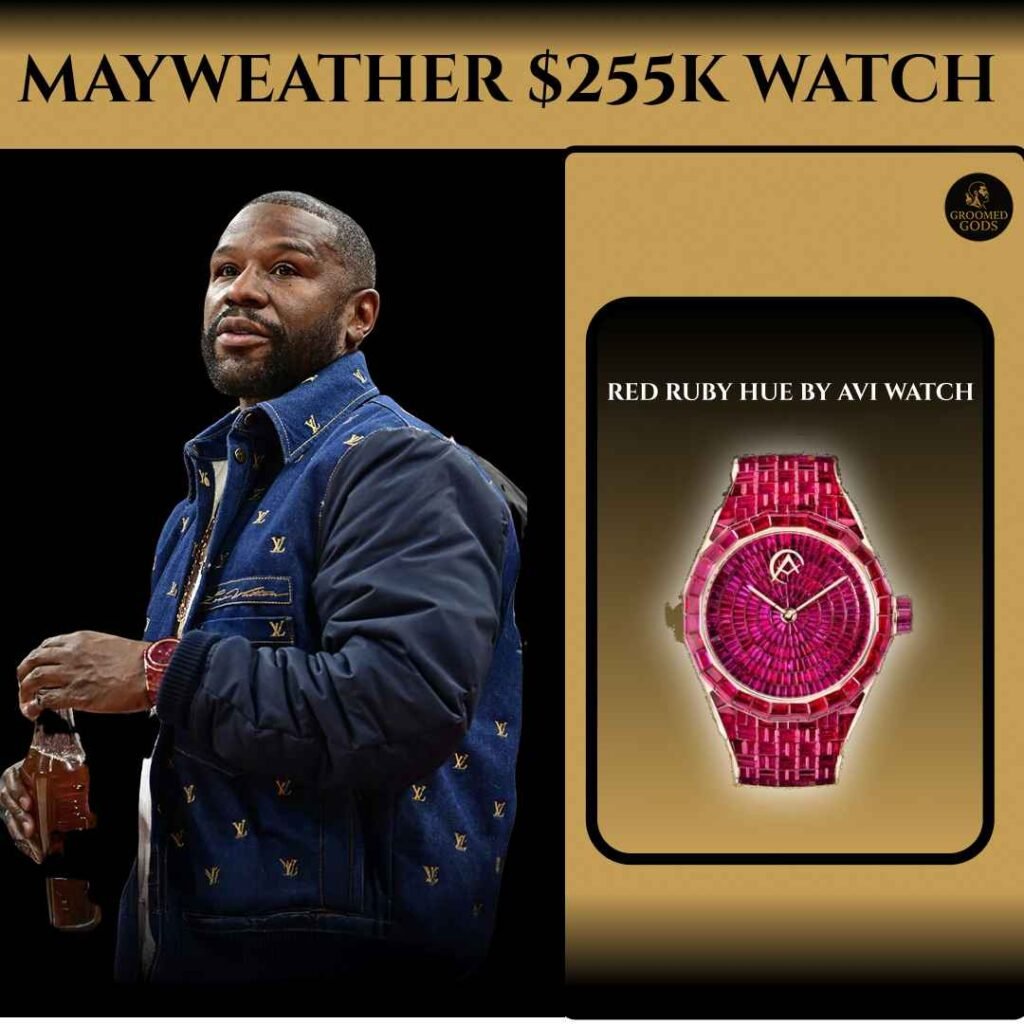 Floyd Mayweather wearing a navy Louis Vuitton jacket beside his $255K Red Ruby Hue by Avi & Co. watch, featuring a full red ruby dial and matching ruby-set bracelet on a gold background.